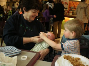 Jack helping feed Lily
