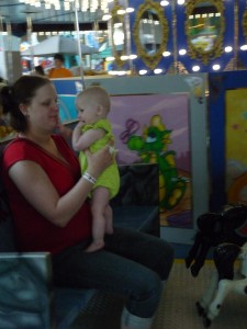 On the carousel with Mommy at Crystal Palace.