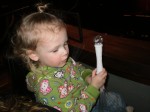 Playing with her light wand, aka remote control